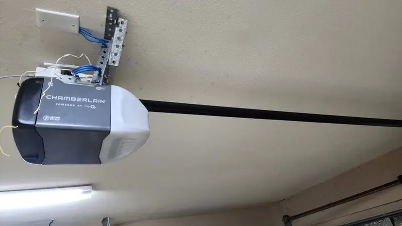 Chamberlain myQ garage door opener mounted on a garage ceiling with its rail
